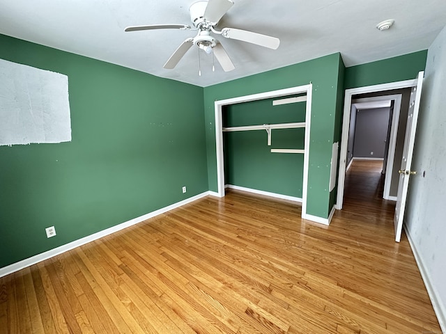 159 Tom Swamp Rd, Hamden, CT 06518 - unfurnished bedroom with light wood-style floors, a closet, ceiling fan, and baseboards