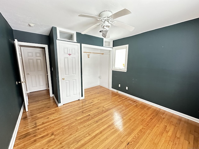 159 Tom Swamp Rd, Hamden, CT 06518 - unfurnished bedroom with light wood finished floors, a closet, a ceiling fan, and baseboards