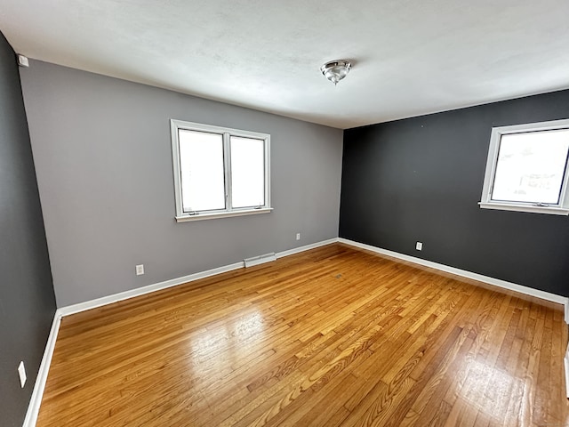 159 Tom Swamp Rd, Hamden, CT 06518 - empty room featuring light wood-style floors, visible vents, plenty of natural light, and baseboards