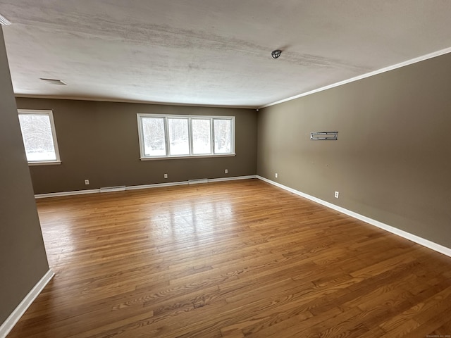 159 Tom Swamp Rd, Hamden, CT 06518 - spare room with visible vents, crown molding, baseboards, and wood finished floors