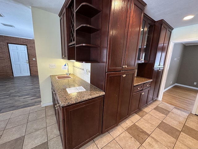 159 Tom Swamp Rd, Hamden, CT 06518 - kitchen with visible vents, dark stone counters, open shelves, a sink, and light tile patterned flooring