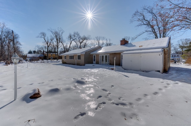 159 Tom Swamp Rd, Hamden, CT 06518 - view of front facade with a garage, a chimney, and french doors