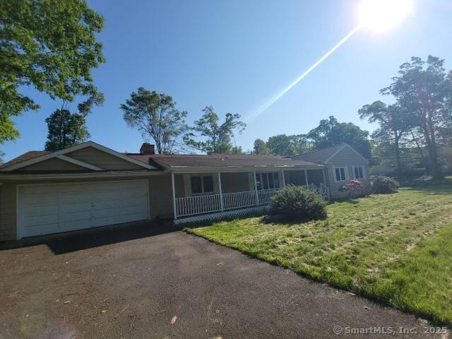 159 Tom Swamp Rd, Hamden, CT 06518 - ranch-style home with a front yard, a porch, asphalt driveway, an attached garage, and a chimney