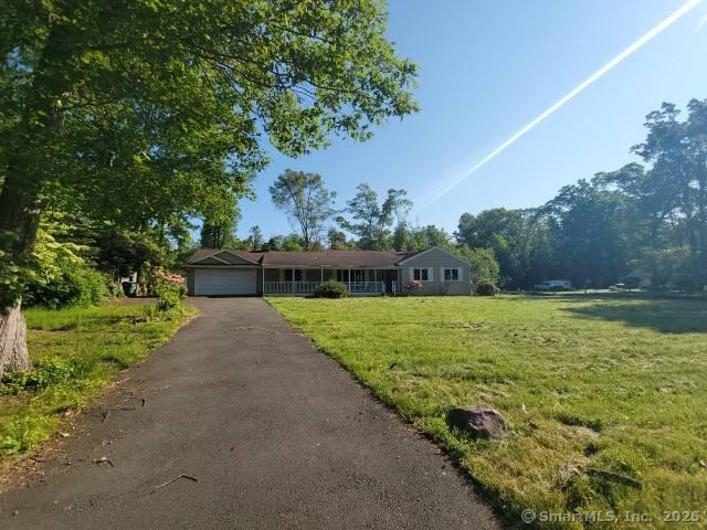 159 Tom Swamp Rd, Hamden, CT 06518 - ranch-style house with a front yard, an attached garage, and asphalt driveway