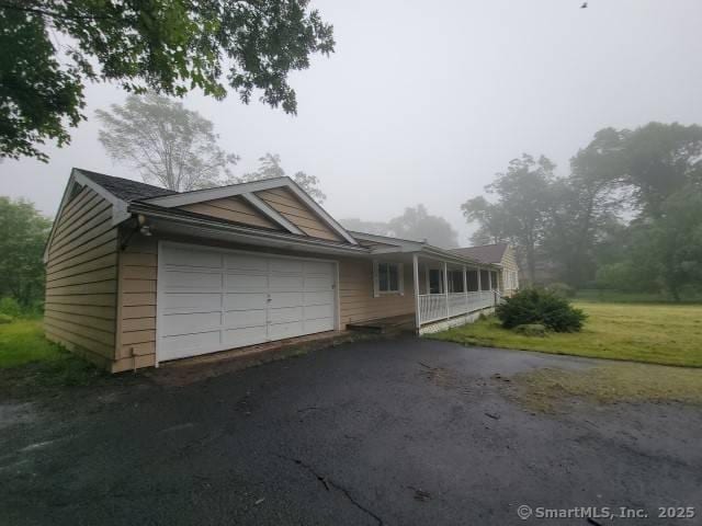 159 Tom Swamp Rd, Hamden, CT 06518 - view of front facade with a garage and asphalt driveway