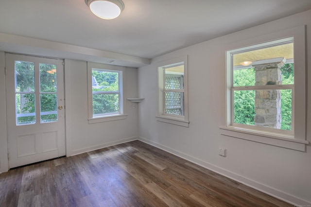 interior space featuring dark wood-style floors and baseboards