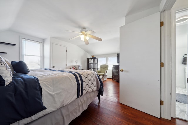 bedroom with ceiling fan, dark wood-type flooring, and lofted ceiling