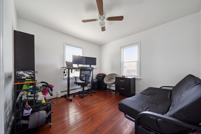 office with a baseboard radiator, a healthy amount of sunlight, a ceiling fan, and hardwood / wood-style flooring