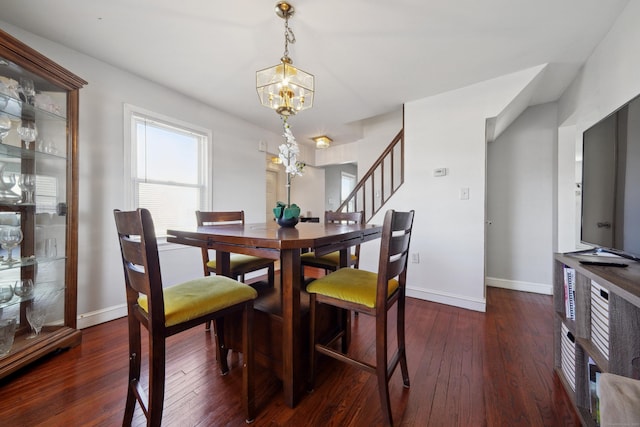 dining area with a notable chandelier, stairway, baseboards, and hardwood / wood-style floors