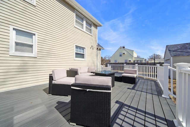 deck featuring outdoor lounge area and fence