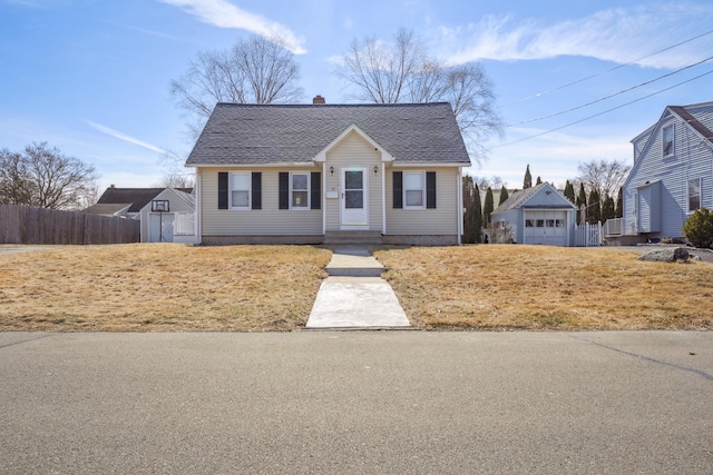 view of front of house with a chimney, an outdoor structure, and fence