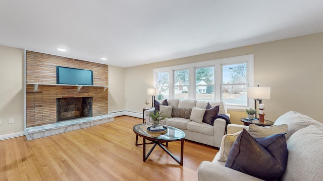 living room featuring recessed lighting, a brick fireplace, wood finished floors, and baseboards