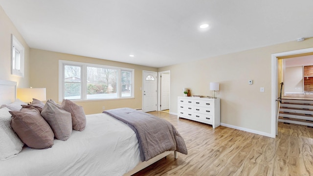 bedroom with baseboards, wood finished floors, and recessed lighting