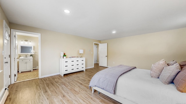 bedroom featuring light wood-style floors, baseboards, baseboard heating, and recessed lighting