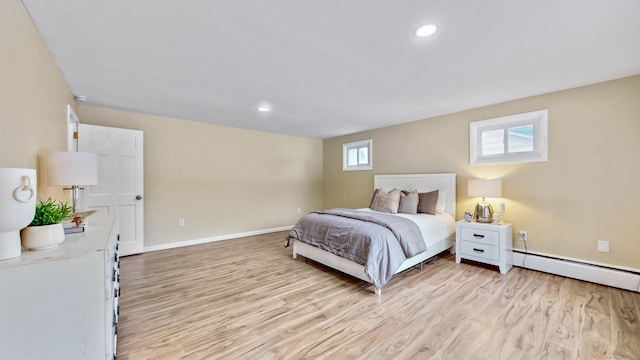 bedroom with light wood finished floors, a baseboard radiator, baseboards, and recessed lighting