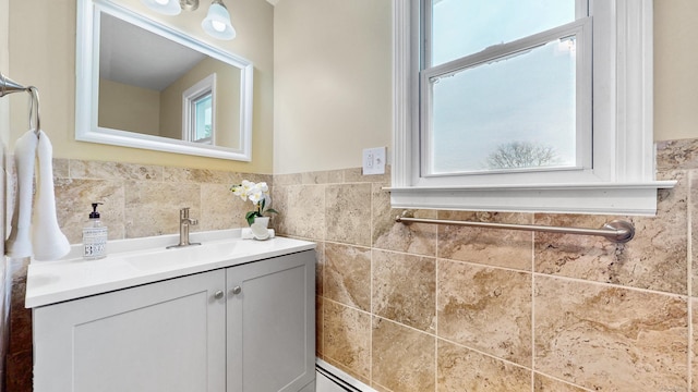 bathroom with wainscoting, tile walls, and vanity