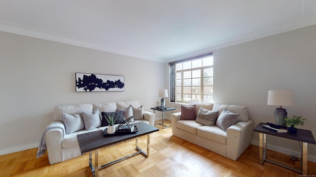 living area with baseboards and crown molding