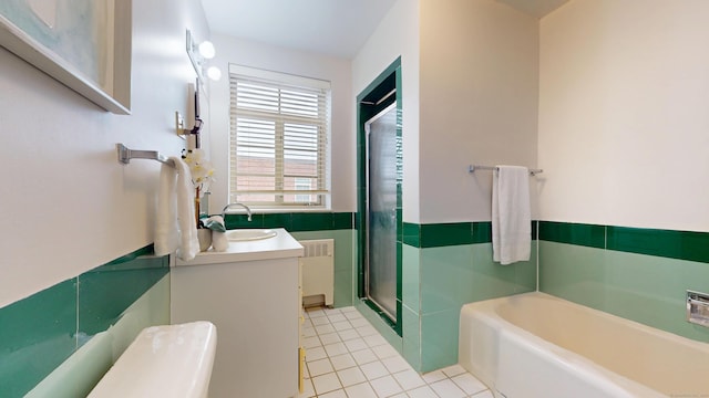 bathroom with a garden tub, tile walls, radiator, a shower stall, and tile patterned floors