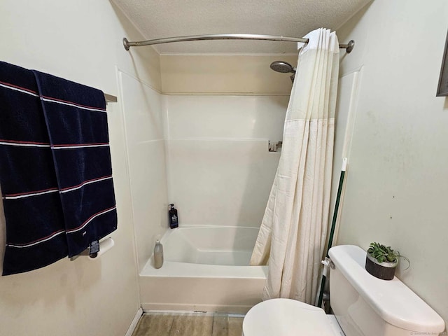 full bath featuring toilet, shower / bath combo with shower curtain, a textured ceiling, and wood finished floors