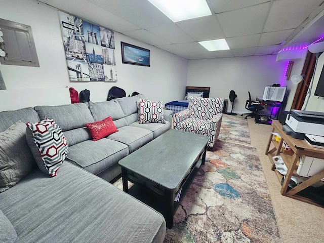 carpeted living room featuring a paneled ceiling