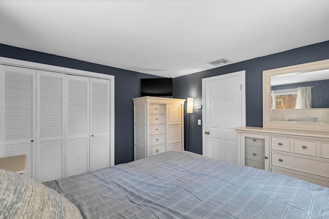 bedroom with visible vents and a closet