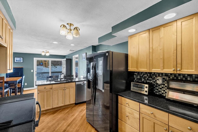 kitchen featuring electric range oven, a sink, dishwasher, light brown cabinetry, and black refrigerator with ice dispenser