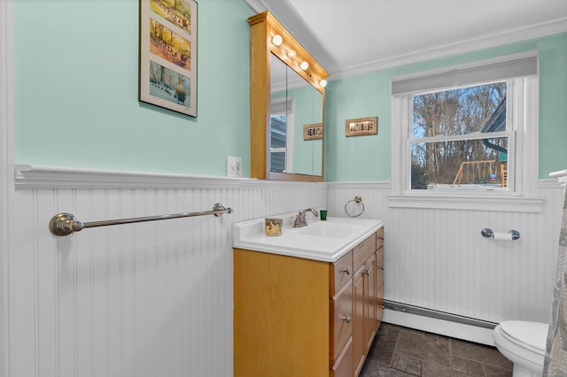 half bathroom featuring a baseboard radiator, toilet, a wainscoted wall, vanity, and ornamental molding