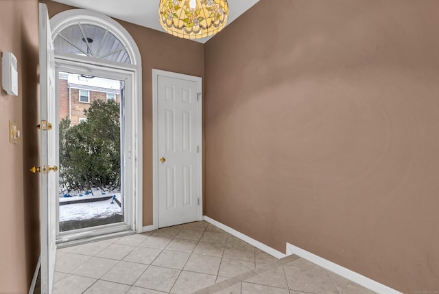 entrance foyer featuring light tile patterned floors and baseboards