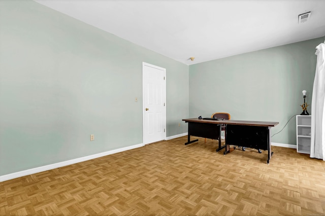 office space with visible vents and baseboards