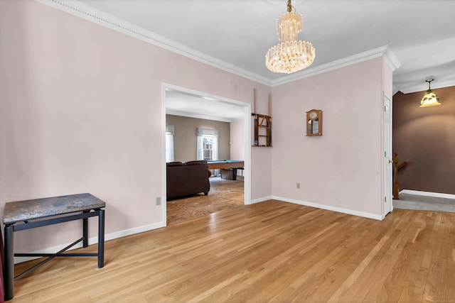 interior space with ornamental molding, baseboards, and light wood finished floors