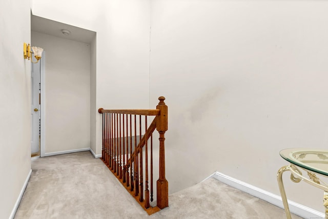 stairs featuring carpet floors and baseboards