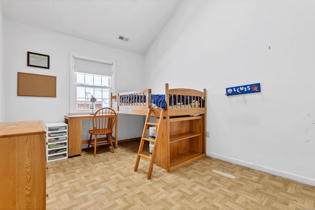 bedroom with lofted ceiling, visible vents, and baseboards