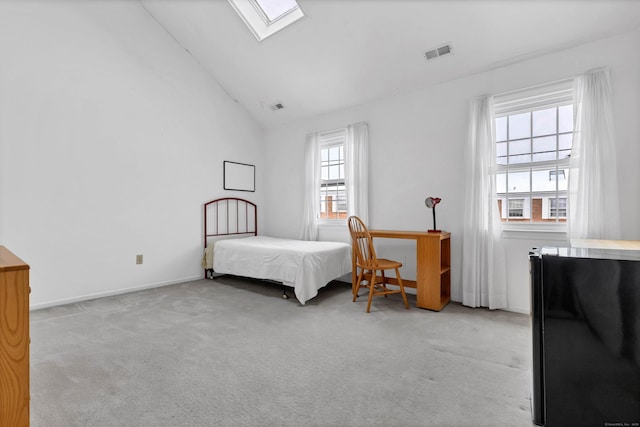 bedroom featuring light carpet, lofted ceiling with skylight, visible vents, and baseboards