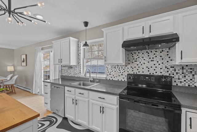 kitchen featuring under cabinet range hood, black range with electric stovetop, a sink, stainless steel dishwasher, and dark countertops