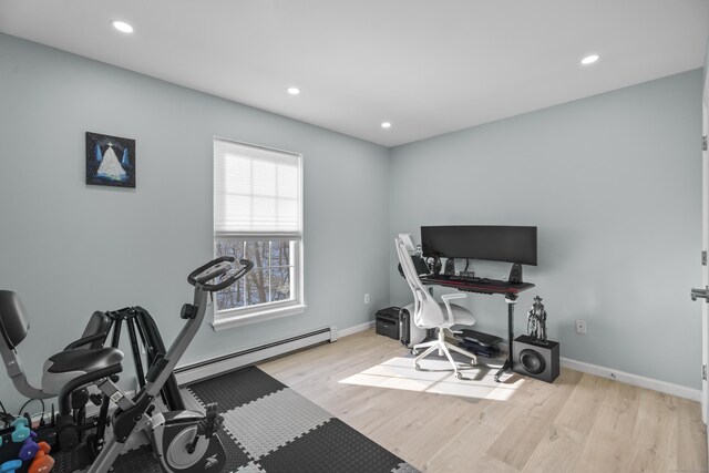 exercise room with baseboards, light wood-type flooring, and recessed lighting