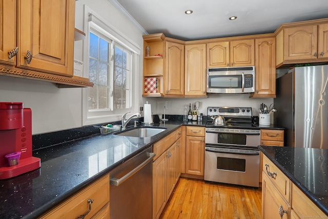 kitchen featuring open shelves, light wood-style flooring, appliances with stainless steel finishes, a sink, and dark stone countertops