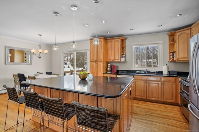 kitchen with a breakfast bar, open shelves, decorative light fixtures, and a center island