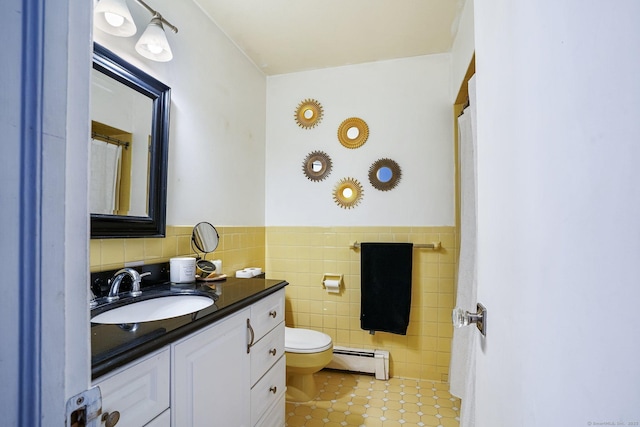 bathroom featuring tile walls, a baseboard radiator, wainscoting, vanity, and tile patterned floors