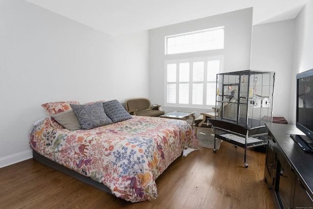 bedroom with hardwood / wood-style flooring and baseboards