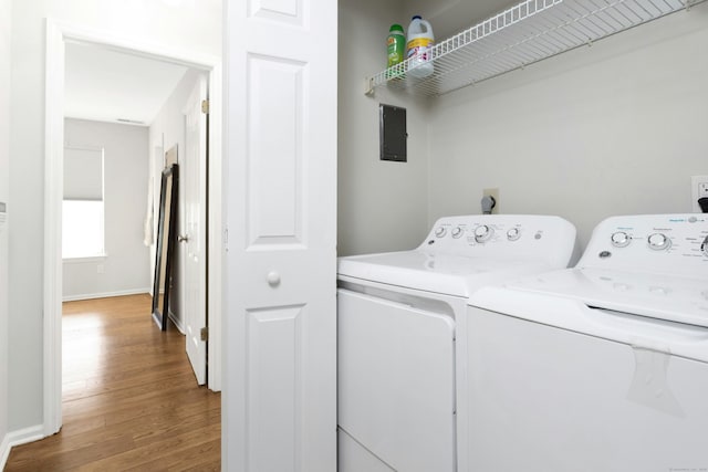 washroom featuring laundry area, independent washer and dryer, wood finished floors, and baseboards