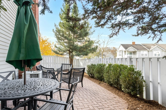 view of patio / terrace featuring outdoor dining space, cooling unit, and a fenced backyard