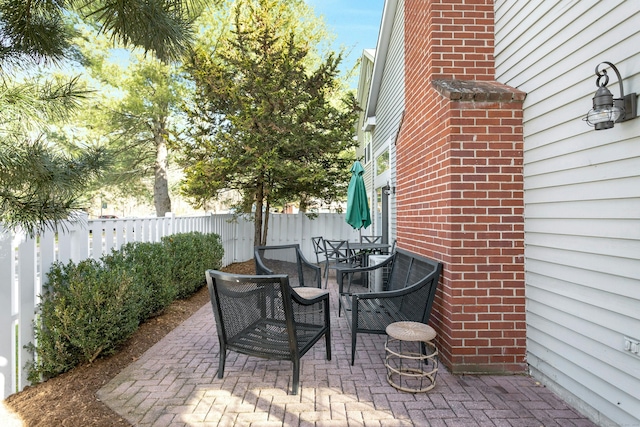 view of patio / terrace featuring outdoor dining space and fence