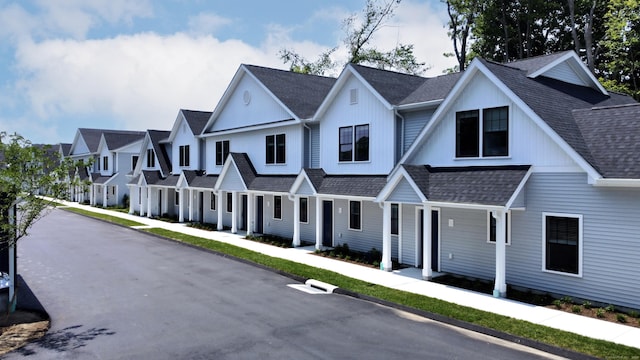 view of front of home featuring a shingled roof and a residential view