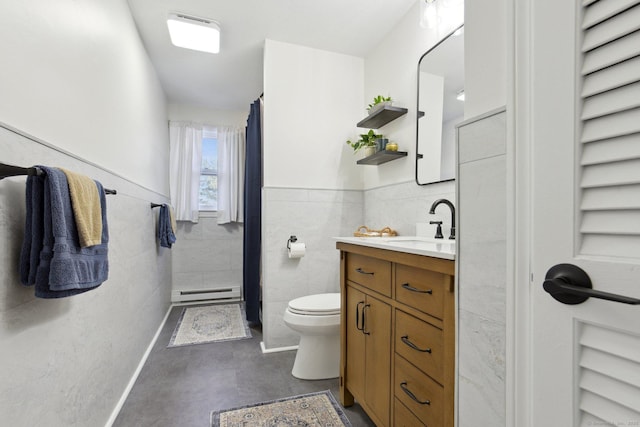 full bath with wainscoting, toilet, a baseboard radiator, vanity, and tile walls