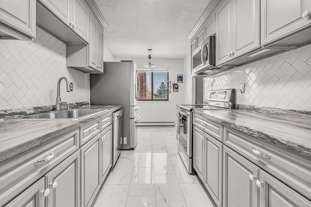 kitchen with a textured ceiling, gray cabinetry, a sink, marble finish floor, and appliances with stainless steel finishes