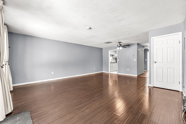 unfurnished living room featuring a ceiling fan, a textured ceiling, baseboards, and wood finished floors