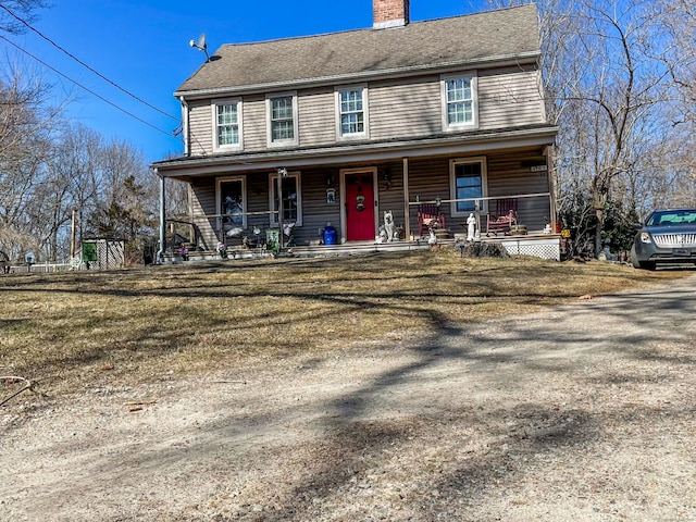 view of front of house featuring covered porch and a chimney