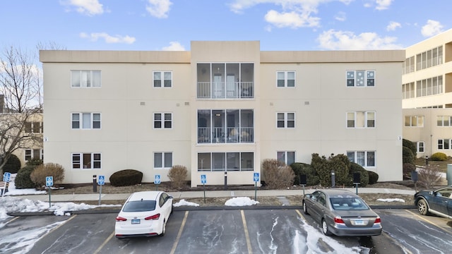 view of building exterior featuring uncovered parking