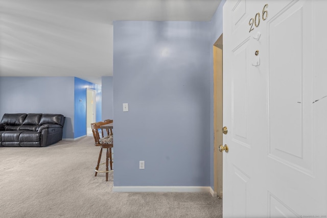 hallway with light carpet and baseboards