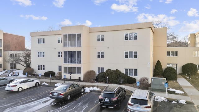 view of building exterior featuring uncovered parking